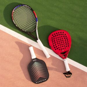 Tennis, padel, and pickleball rackets on a vibrant multi-colored court.